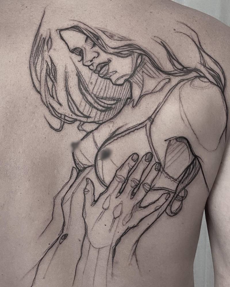 Sketch work style woman tattoo located on the shoulder blade.