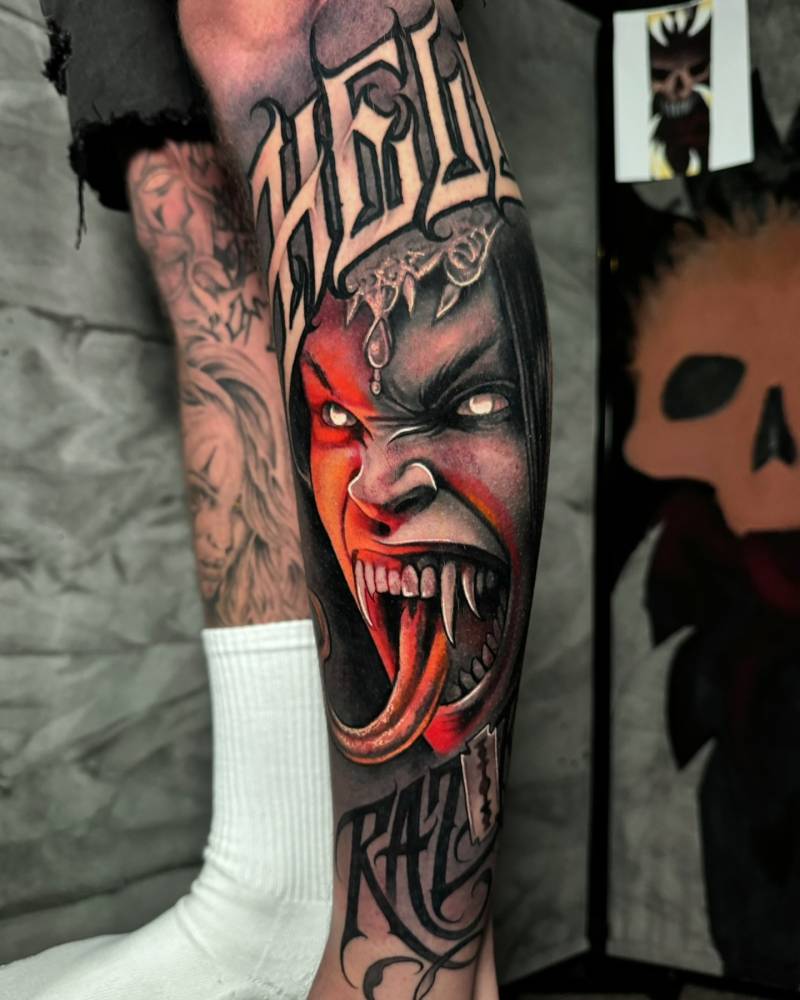 Vampire girl portrait tattoo located on the shin.