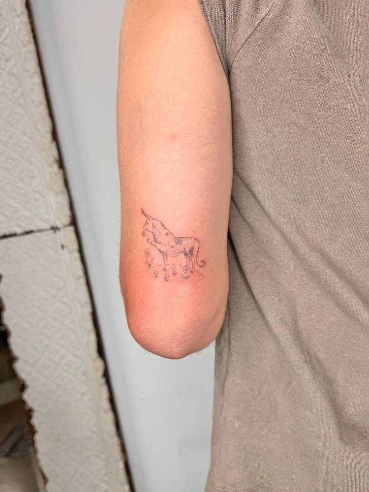 Ferdinand the Bull tattoo located on the tricep.
