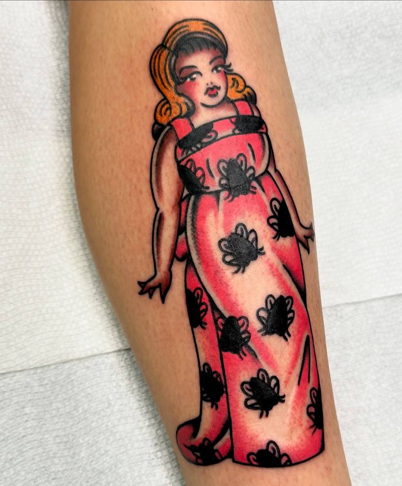Tracy Turnblad from 'Hairspray' tattooed on the shin, traditional style.