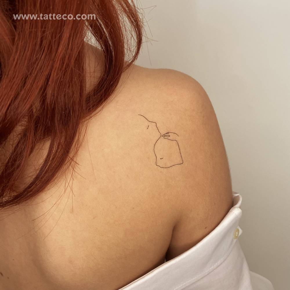 Mother love temporary tattoo located on the shoulder blade.