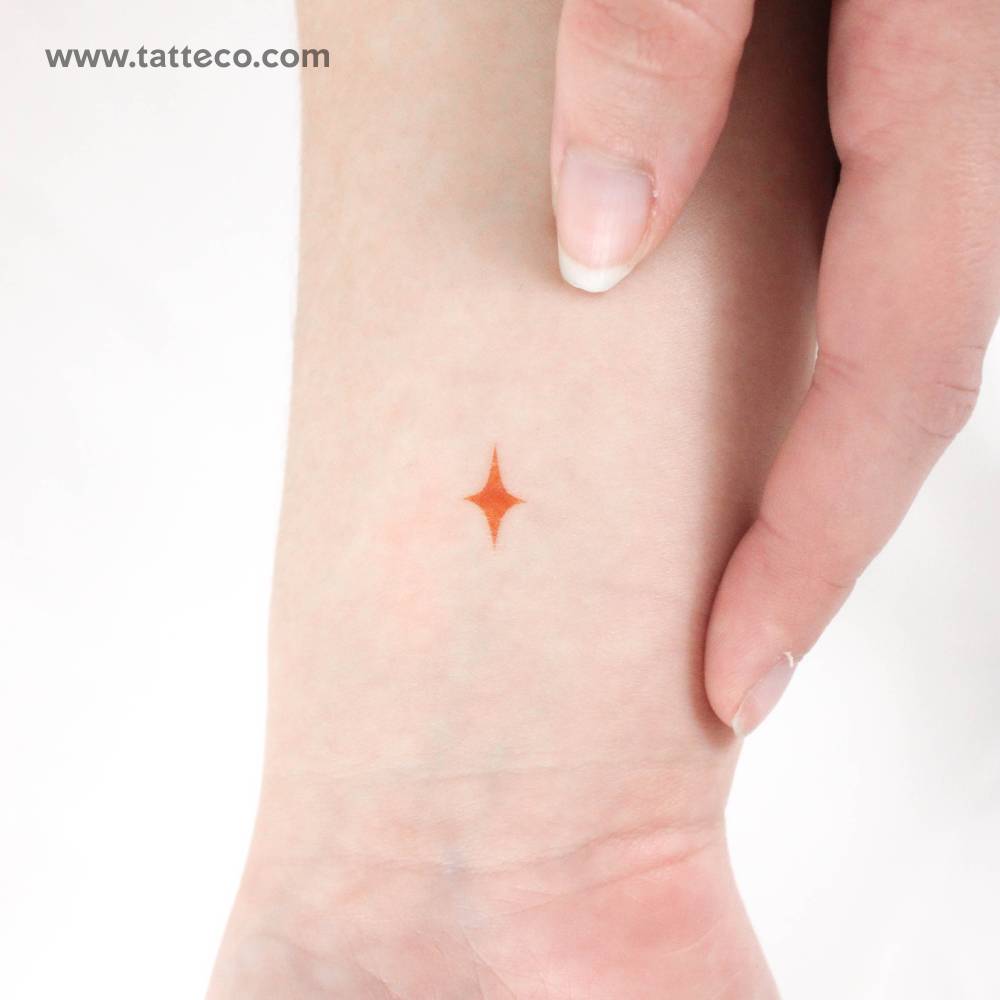 Yellow star temporary tattoo located on the wrist.