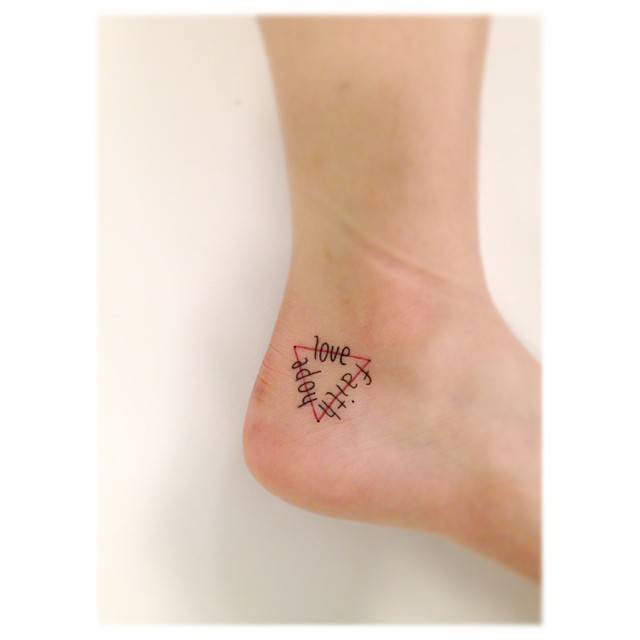 Faith, hope, love triangle tattoo located on the ankle.