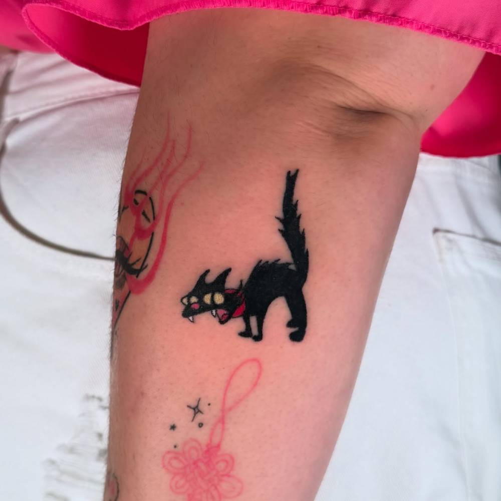 Snowball tattoo located on the forearm, cartoon style.