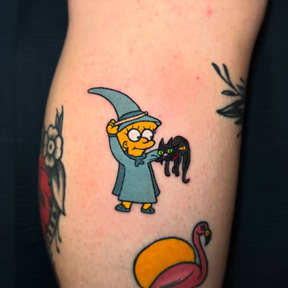 Witch Lisa and Snowball tattoo located on the calf, cartoon style.