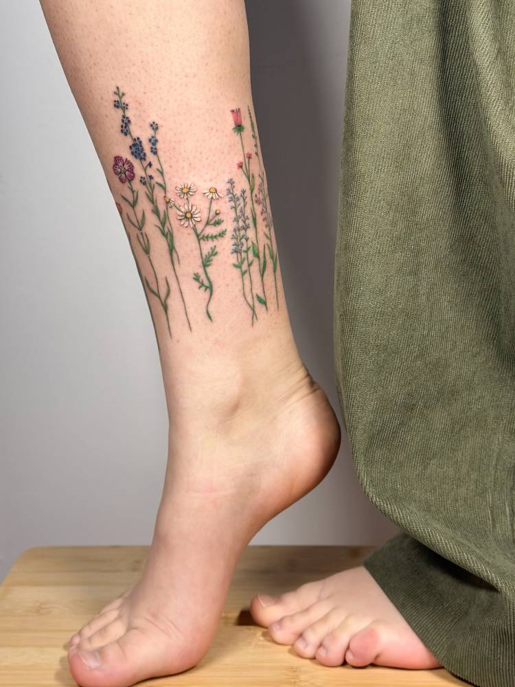 Flower collection tattooed on the ankle.