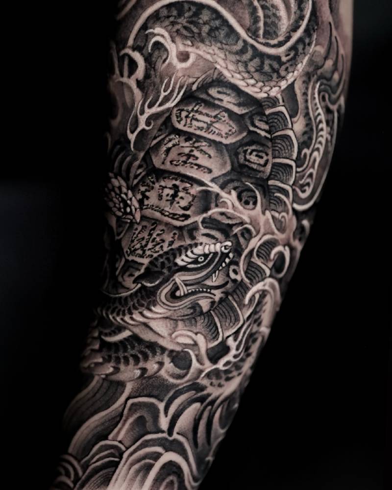 Snake tattoo in oriental style located on the forearm.