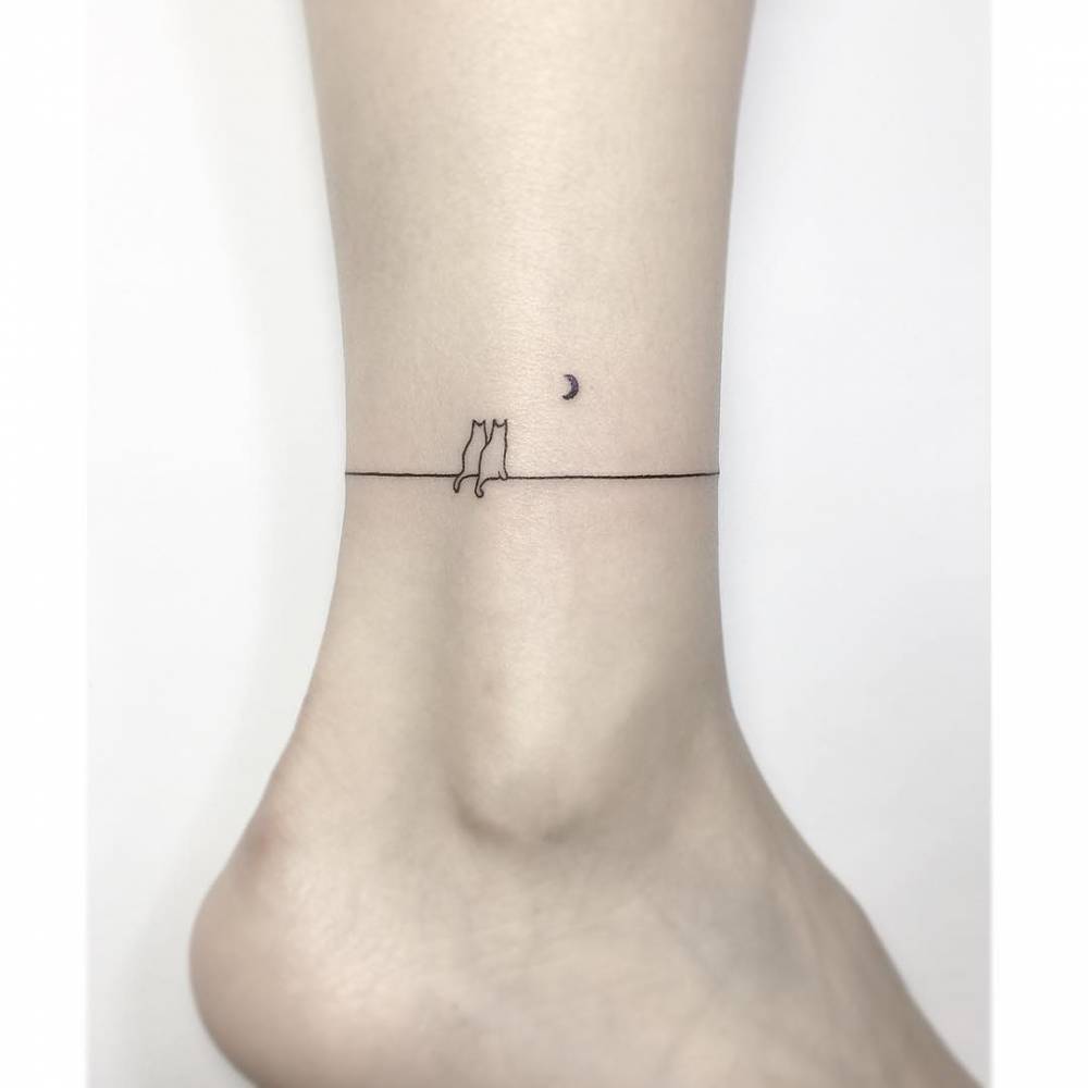 Cat couple ankle band tattoo in minimalistic style.