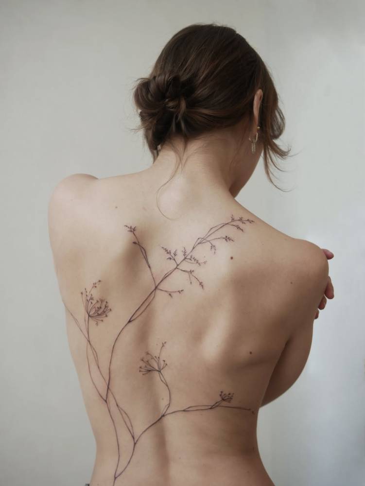 Back composition flower tattoo in illustrative style.