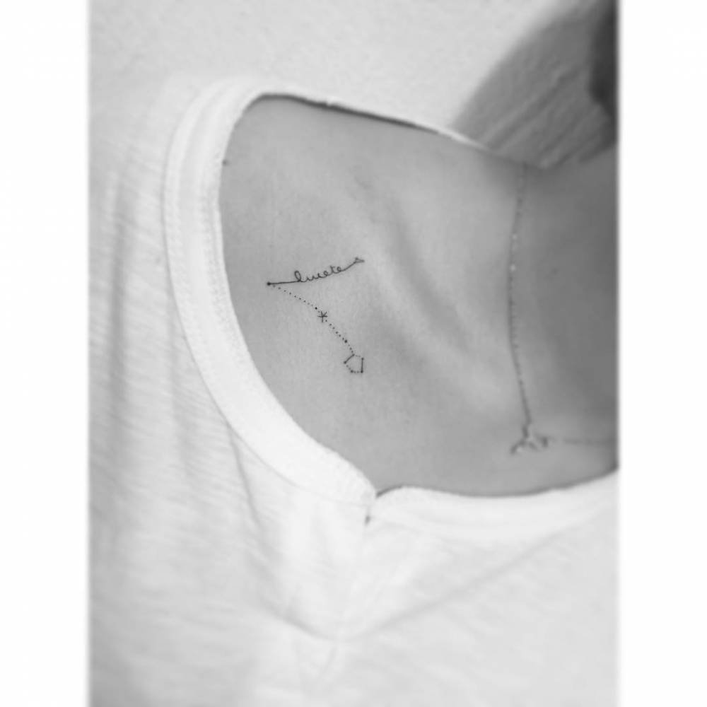 Pisces constellation and word "lucete" tattooed on the collarbone.