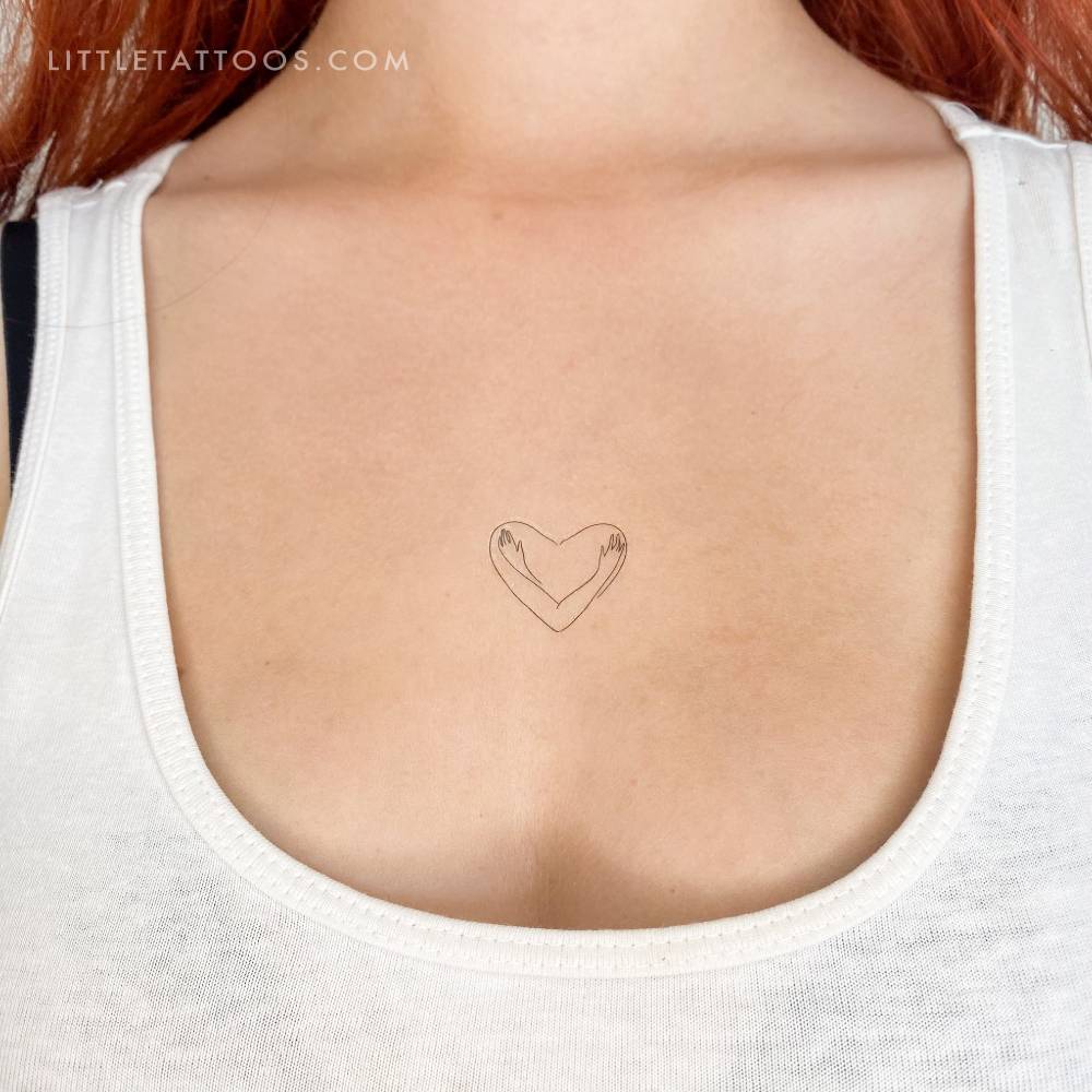 Fine line style self hug temporary tattoo located on the chest.
