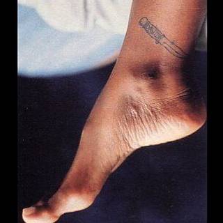 Healed knife tattoo located on Alexandria Zahra Jones's ankle.