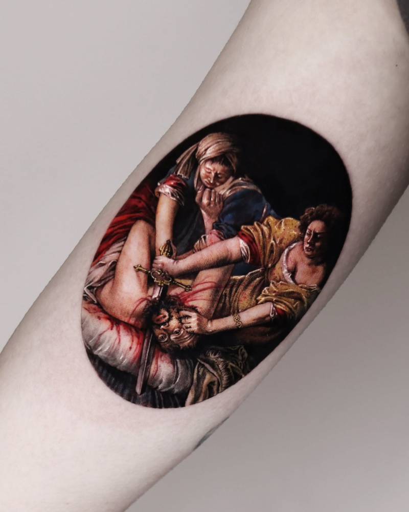 'Judith Beheading Holofernes' tattooed on the inner arm.