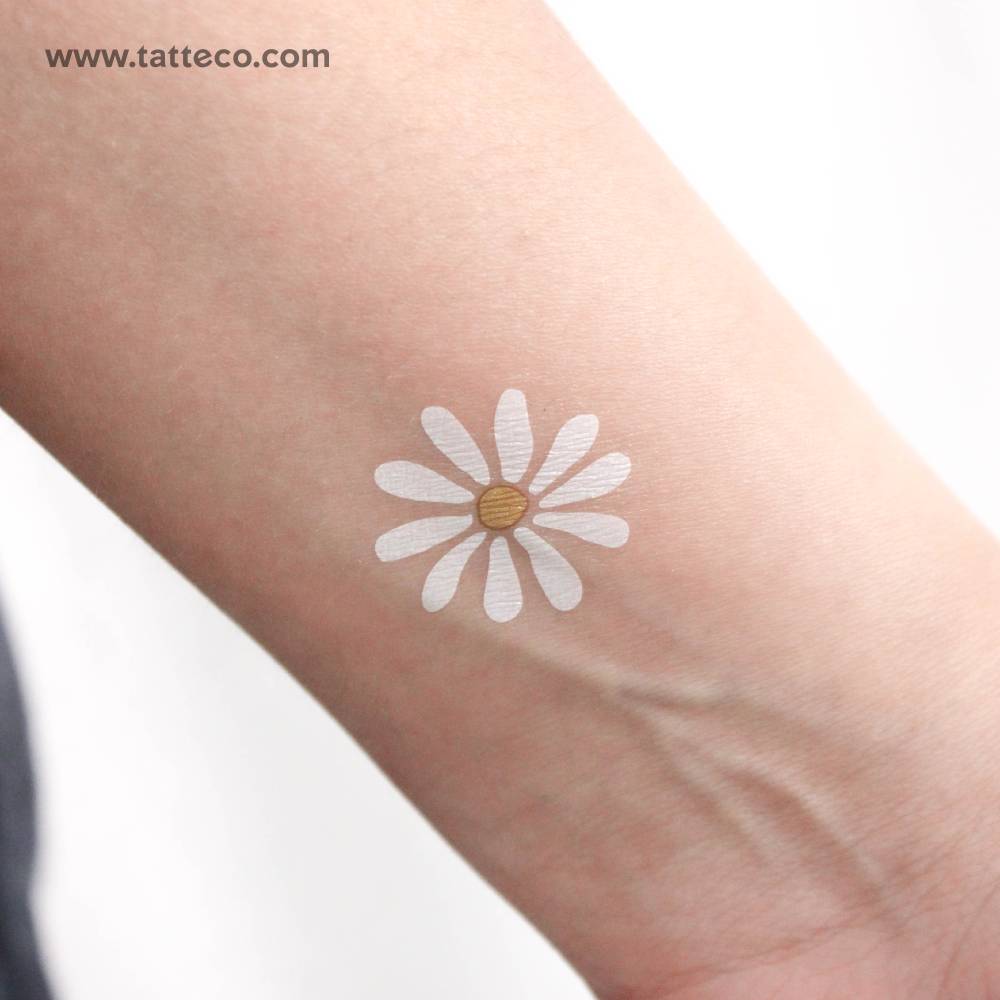 Watercolor style white daisy temporary tattoo located on the wrist.