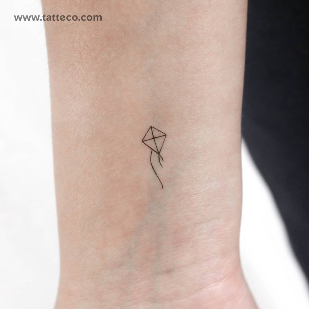Minimalist kite temporary tattoo located on the wrist.