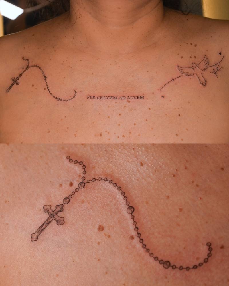 Rosary and dove tattoo located on the collarbone.