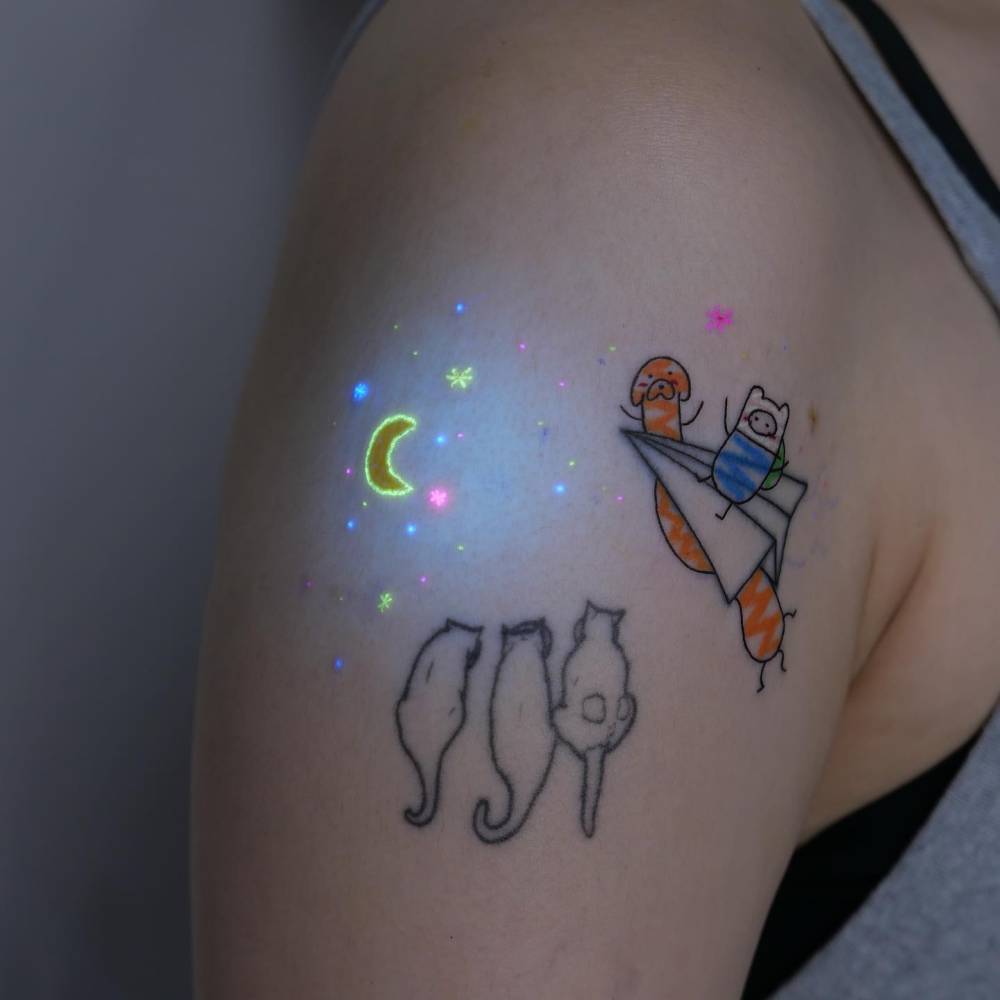 Jake the Dog and Finn the Human tattooed on the upper arm.