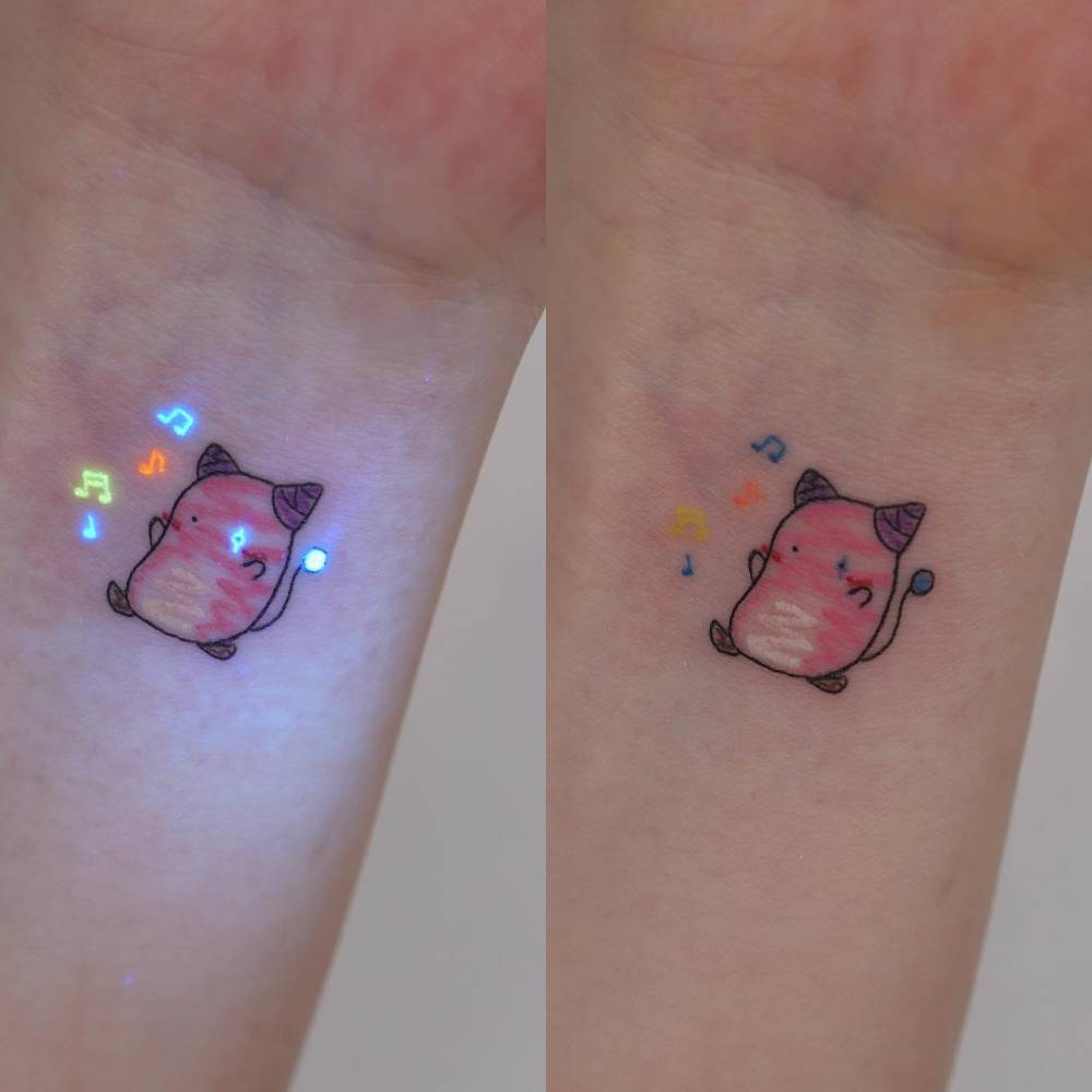 Pink Bean from MapleStory tattooed on the wrist, cartoon style.