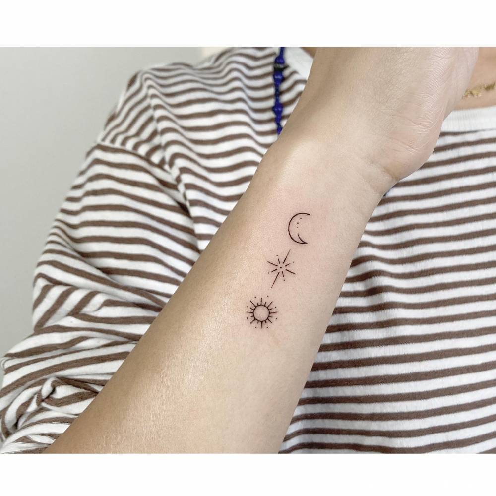Crescent moon, north star and sun tattoo in minimalistic style.