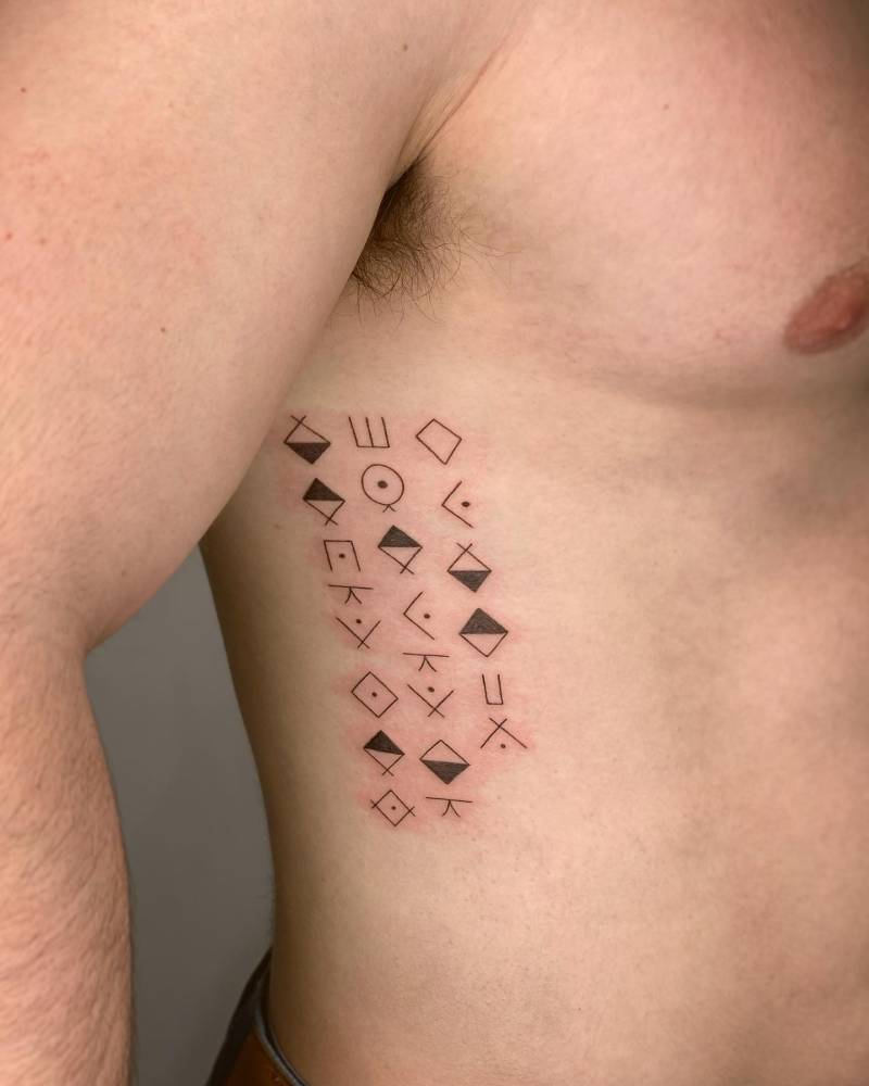 Runes tattoo located on the rib.