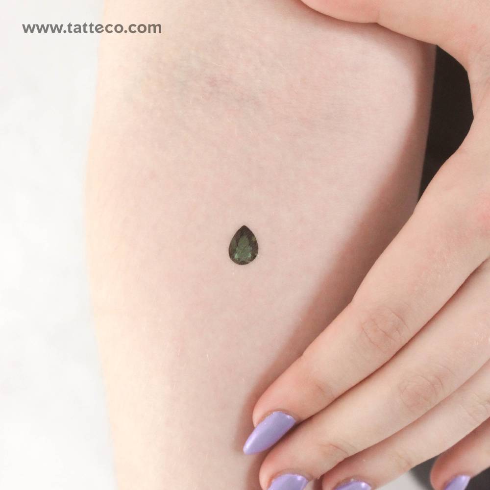 Emerald green pear cut temporary tattoo located on the inner forearm.
