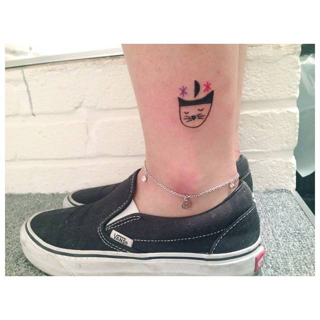 Illustrative style cat tattoo located on the ankle.