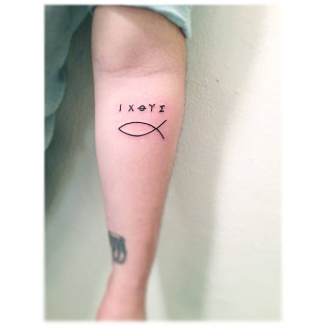 Jesus fish tattoo done on the inner forearm, minimalistic style.
