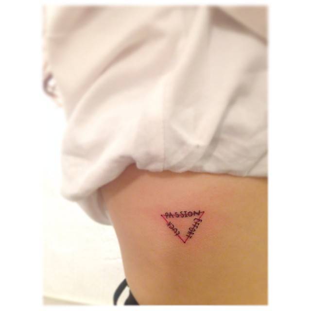 "Passion", "effort" and "luck" triangle tattooed on the rib.