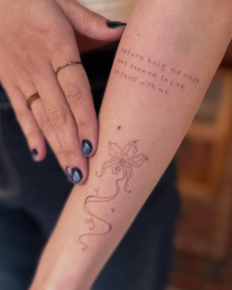 "Nature held me close and seemed to find no fault with me" and orchid tattooed on the forearm.