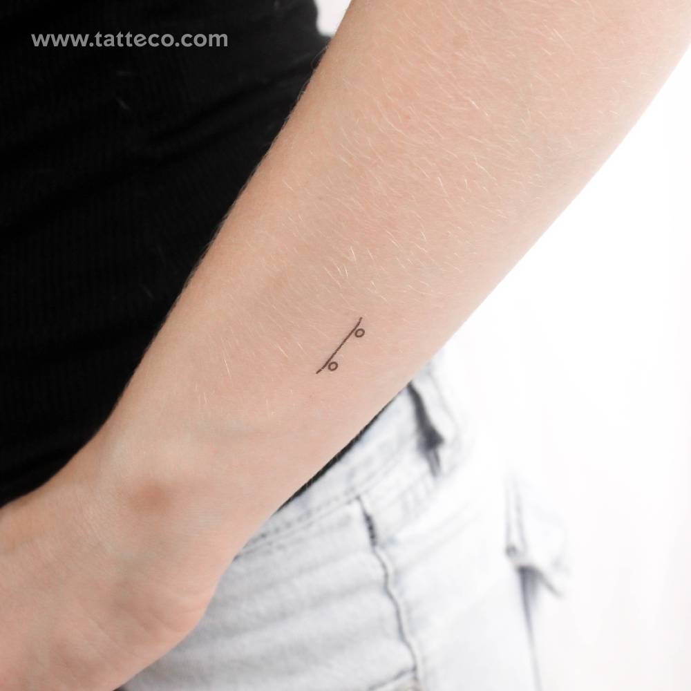 Minimalist style skateboard temporary tattoo located on the wrist.