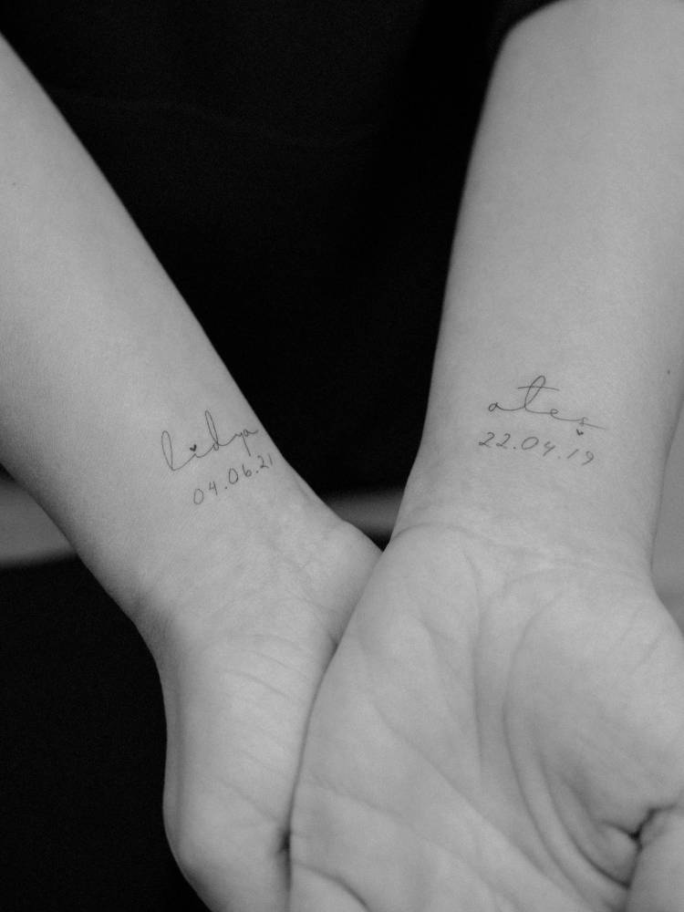 Individual matching names and dates tattooed on the wrist.