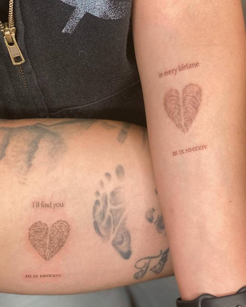 Matching fingerprint heart and "I'll find you in every lifetime" tattoo for couple.