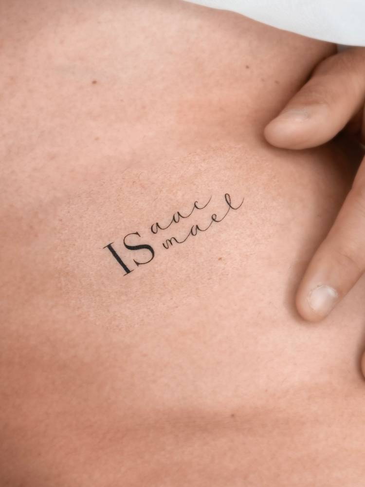 Names "Isaac" and "Ismael" tattooed on the rib.