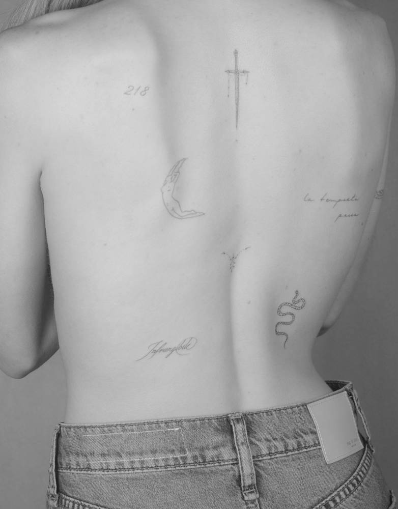 Back composition tattoos in fine line style.
