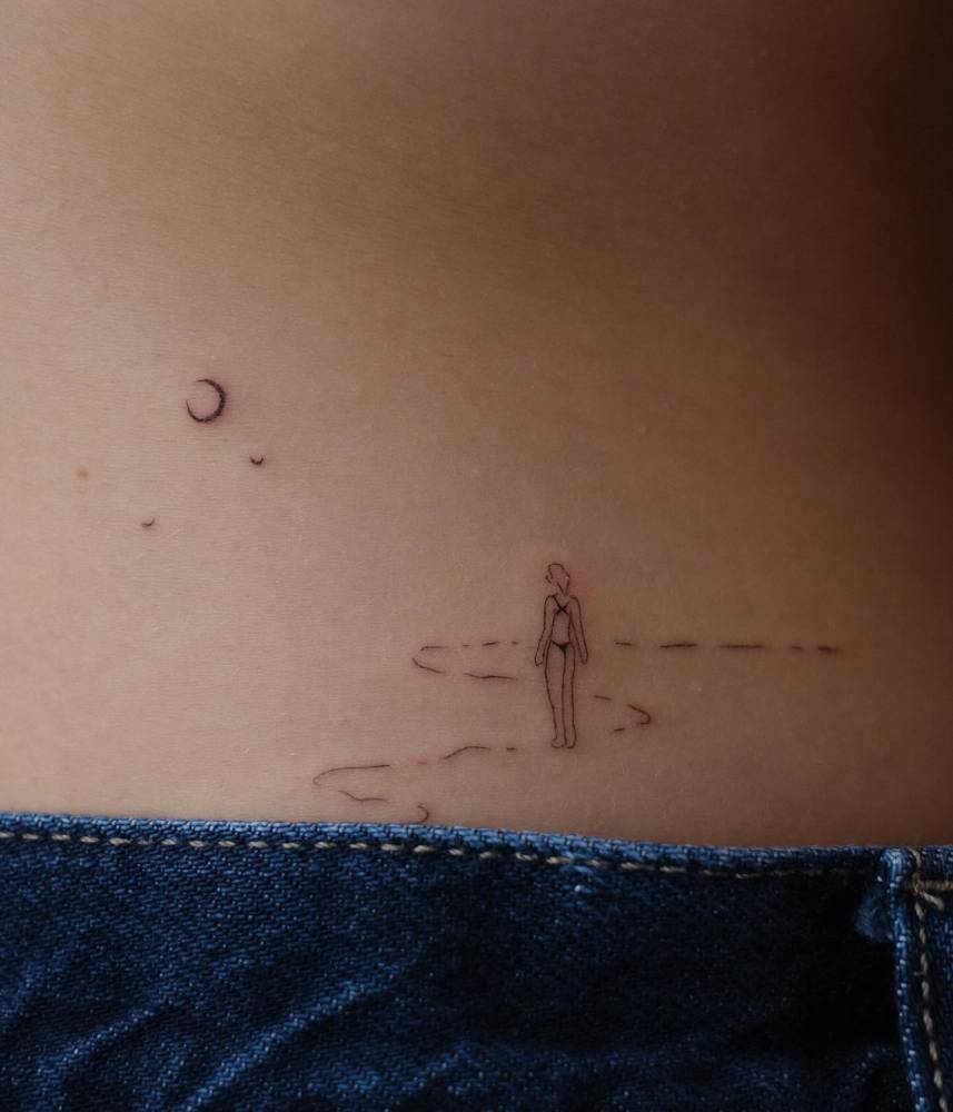 Beach tattoo in minimalistic style located on the lower back.