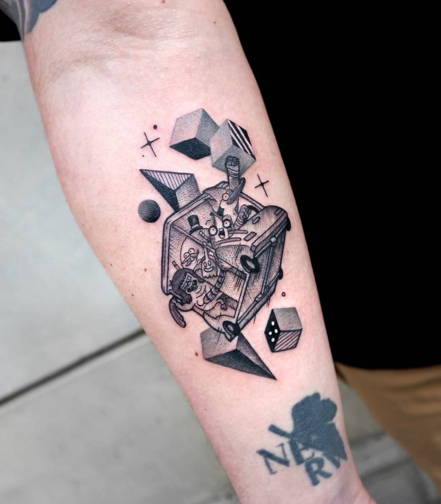 Regular Show tattoo located on the inner forearm, cartoon style.