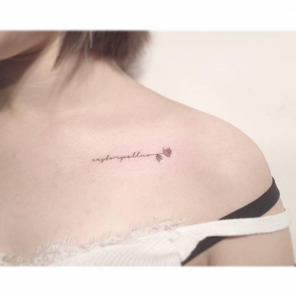 "Castorpollux" and pink rose tattoo located on the collarbone.