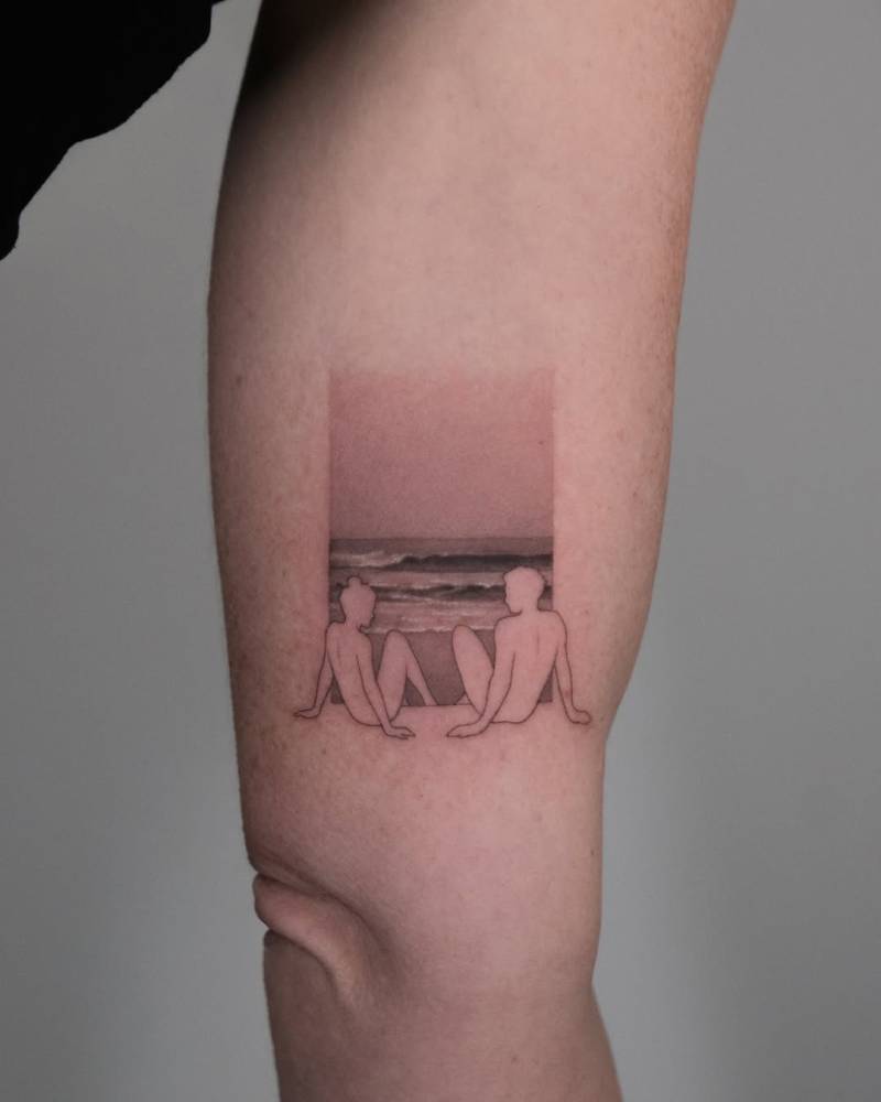 Beach tattoo in pop art style located on the inner arm.