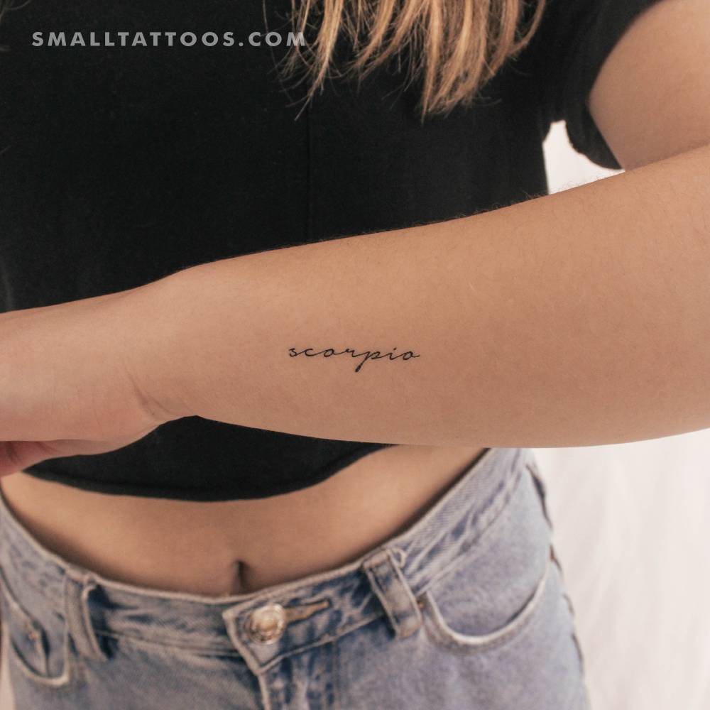 Handwritten font word "Scorpio" temporary tattoo located on the wrist.