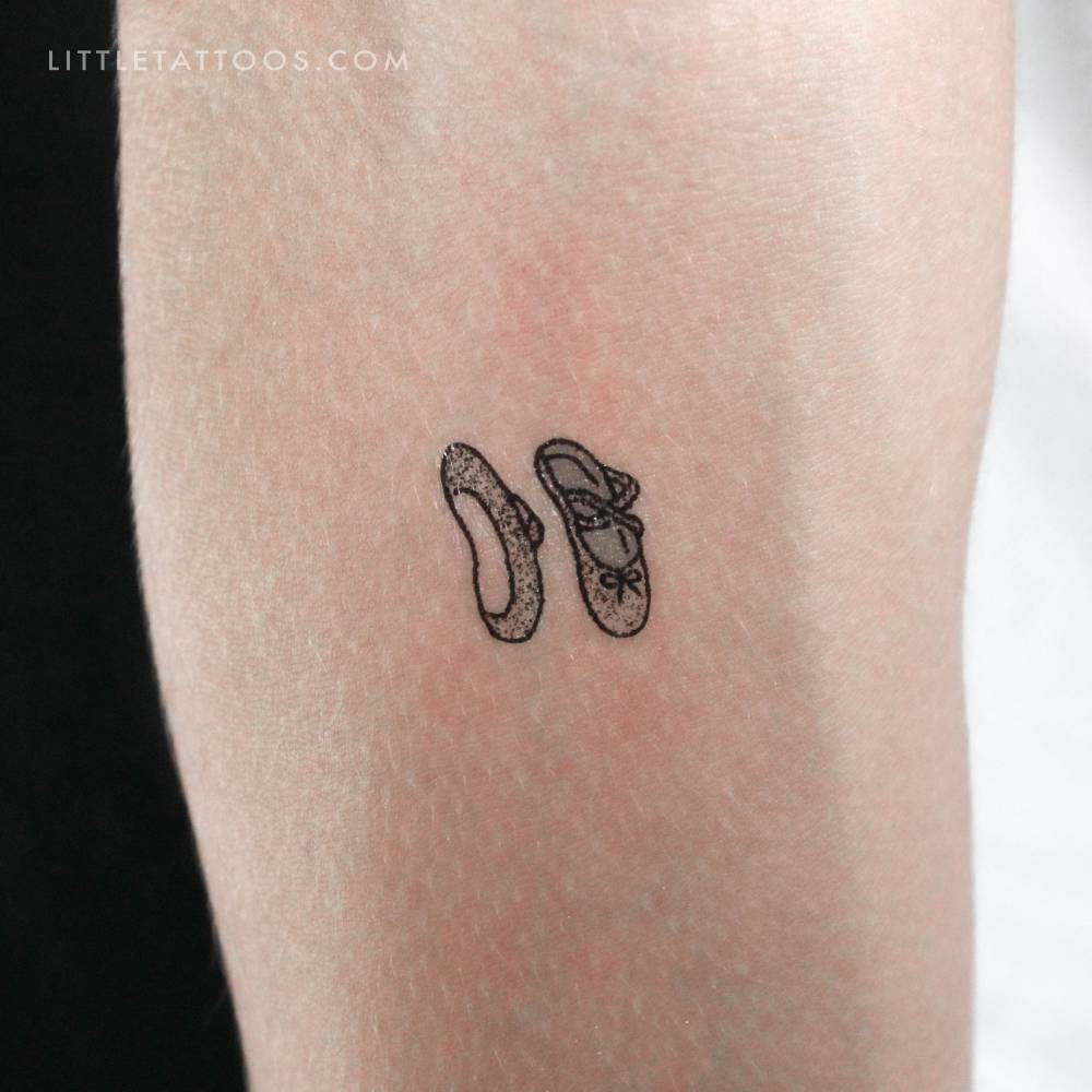 Little ballet shoes temporary tattoo located on the inner forearm.