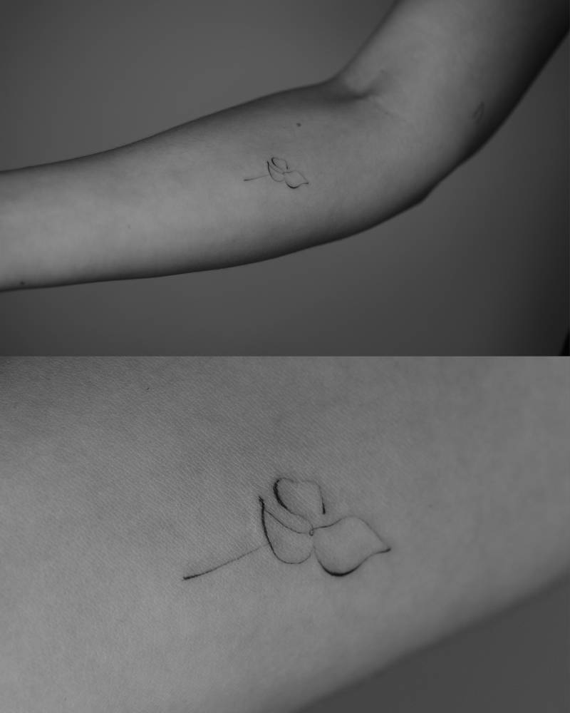 Abstract flower tattoo located on the inner forearm.