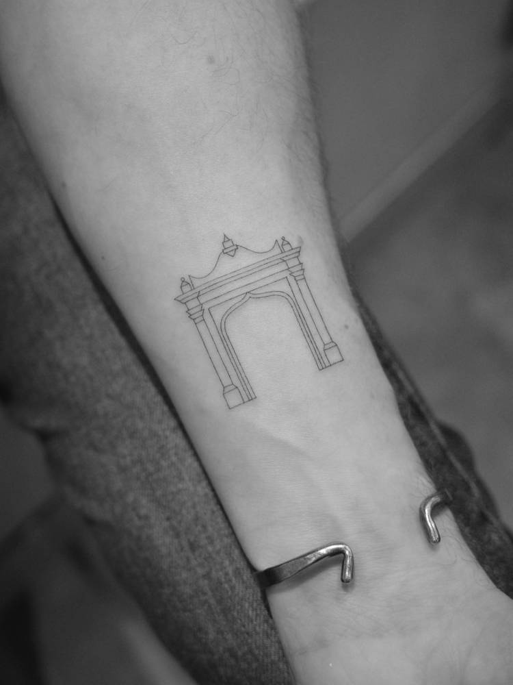 Fine line style archway tattoo located on the wrist.