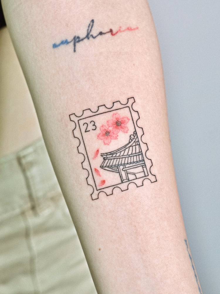 Korean stamp tattoo in fine line style located on the inner forearm.