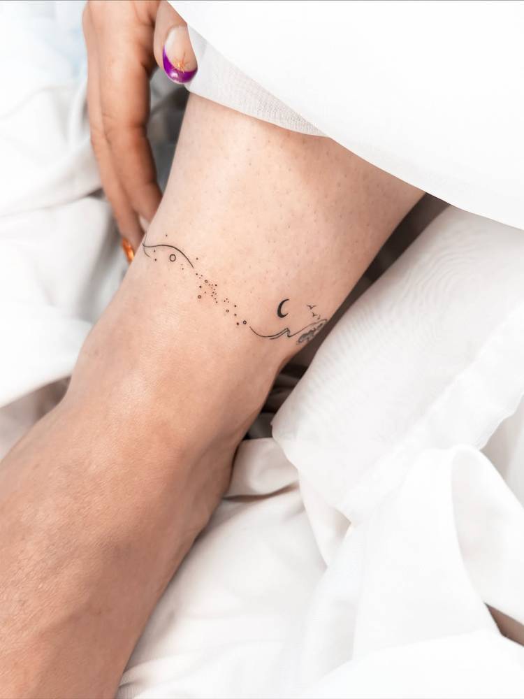Galaxy ankle band tattoo done in fine line style.