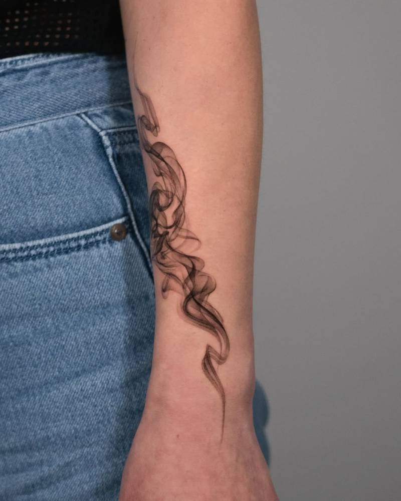 Abstract smoke tattoo located on the forearm.