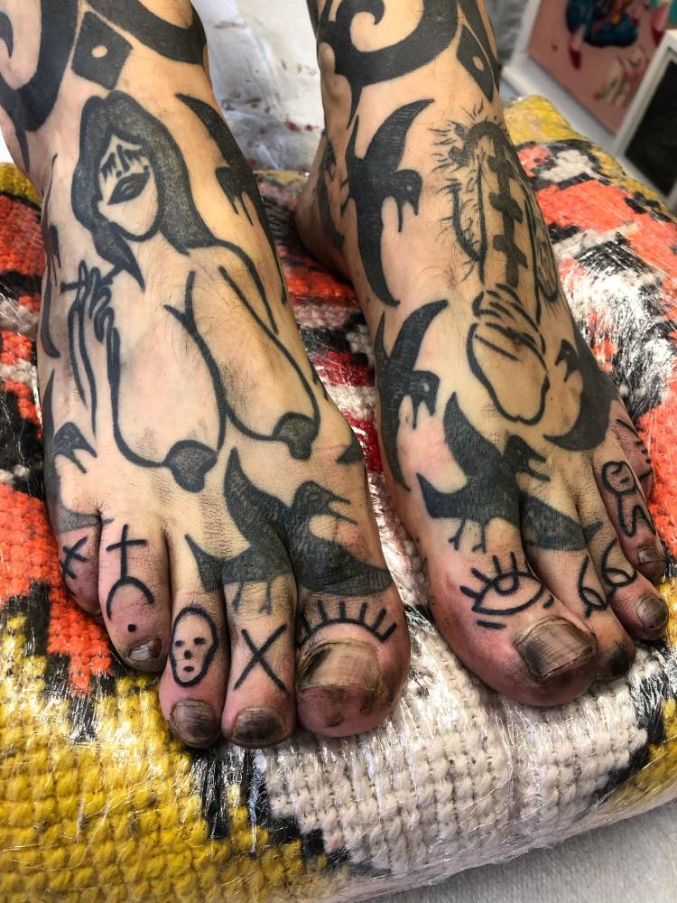 Hand poked mini tats done on the toes.