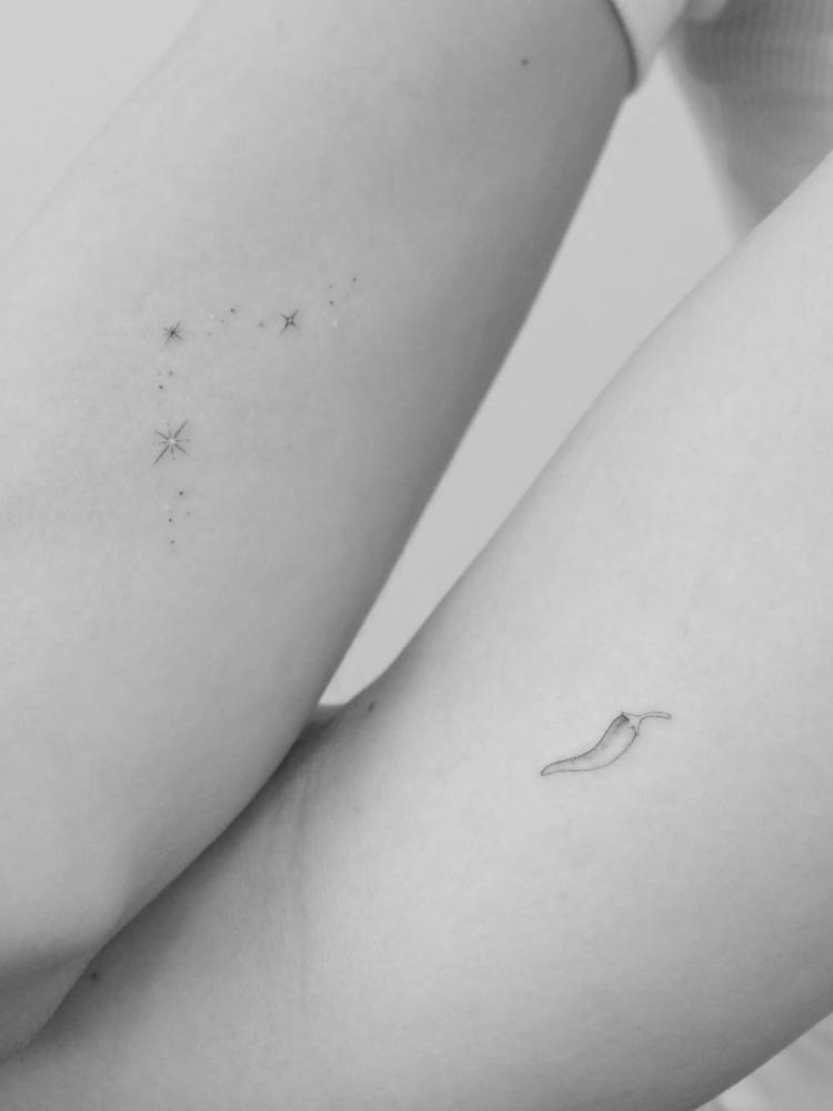 Sparkling stars and chili pepper tattoos in fine line style.