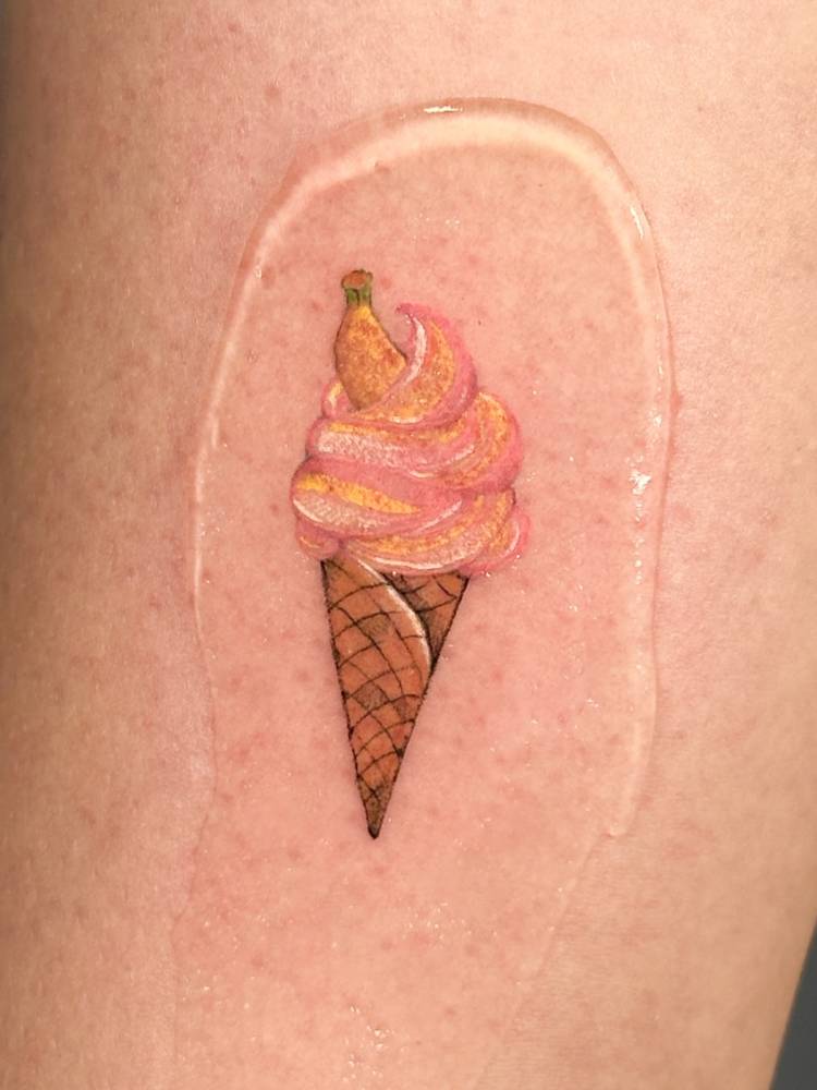 Ice cream cone and banana tattoo located on the thigh.