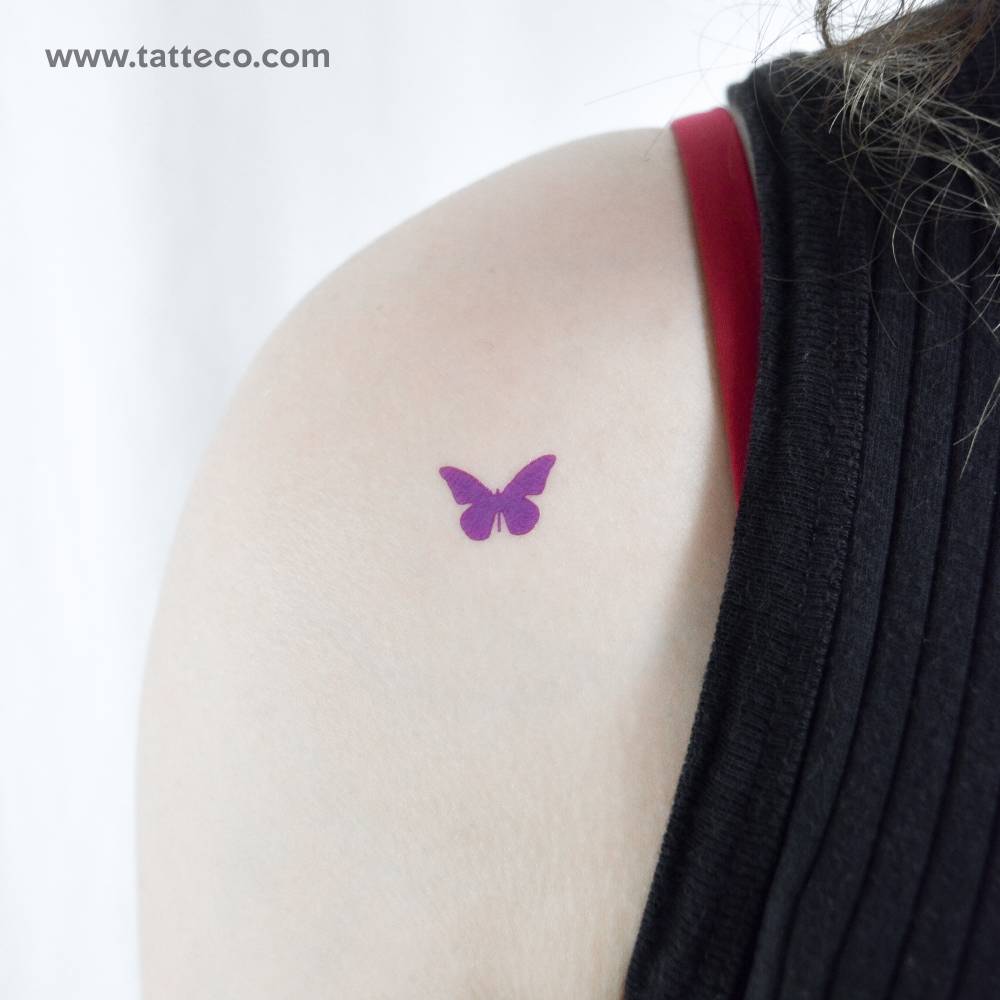 Little purple butterfly temporary tattoo located on the shoulder.