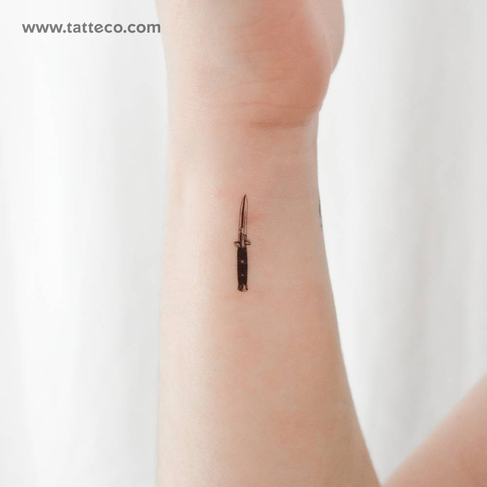 Stiletto automatic knife temporary tattoo located on the wrist.